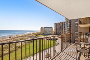 a balcony with a view of the beach and condos at Sea Colony - 604 Dover House Rd. in Bethany Beach