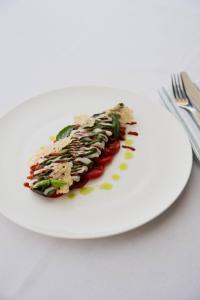a white plate with a piece of food on it at Boutique Hotel Pachers in Bressanone