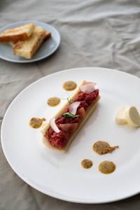 a white plate with a piece of food on it at Boutique Hotel Pachers in Bressanone