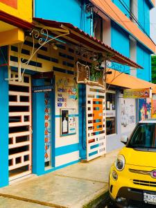 a yellow car parked in front of a building at Piso 11 in Palenque