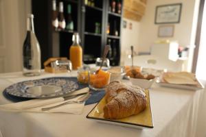 a table with a plate of bread on a table at Masseria Monache in San Pietro Vernotico