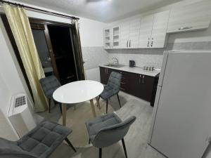 a small kitchen with a white table and chairs at Apartment Alisha in Cazin