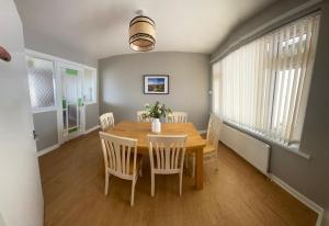 a dining room with a wooden table and chairs at Micona in Newcastle