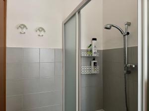 a shower with a glass door in a bathroom at Casa di Peppa in Sanremo