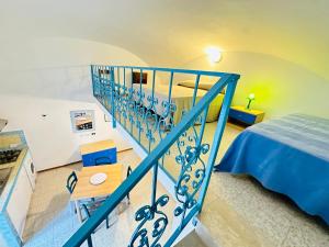 a blue staircase in a room with a bed at Margherita - Immobilevante in Ponza +9 photos