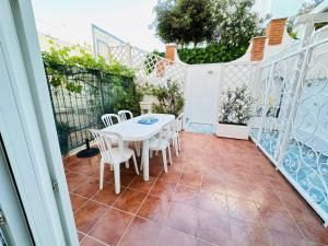a white table and chairs on a patio at Margherita - Immobilevante in Ponza