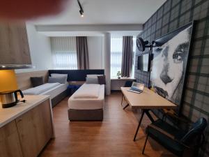 a living room with a couch and a table at my MINGA Airport serviced Apartments in Hallbergmoos