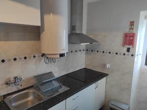 a kitchen with a sink and a stove at Casa do Alentejo in Évora Monte +25 photos