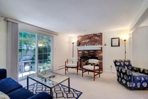 a living room with a couch and chairs and a fireplace at Walk to Nauset Beach NEW AC System in Orleans