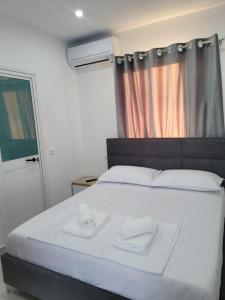Postel nebo postele na pokoji v ubytování CACA Hotel