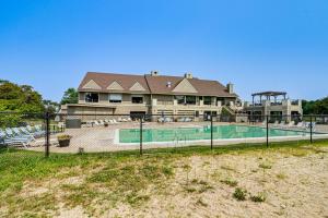 a house with a swimming pool in front of a house at Onamia Vacation Rental about 1 Mi to Mille Lacs Lake! in Isle