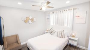 a white bedroom with a bed and a ceiling fan at Xlnc Exotic Home Gillespie Drive in Spring Valley
