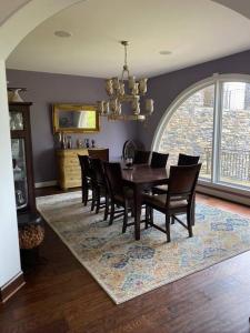 a dining room with a table and chairs on a rug at The Big House on Pleasant Valley Farm in Columbia