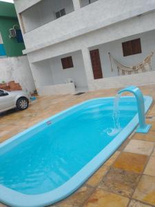 a pool with a water fountain in a yard at Casa Praia BRISAMAR in Maragogi