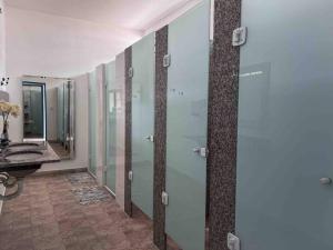 a bathroom with glass shower stalls and a sink at Casa Acuri in Jacareí +16 photos