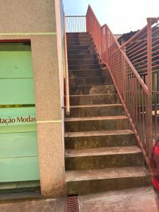 a set of stairs next to a building at Casa 1 andar confortável in Dourados