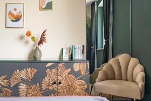 a bedroom with a chair and a dresser at Sonnendeck Schwerin in Schwerin