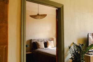 a bedroom with a bed and a mirror at K&L Old Town Kuldīga in Kuldīga
