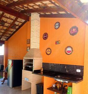a kitchen with a stove with stickers on the wall at Sobrado Quintal Grande 10 min do Centro in Caraguatatuba