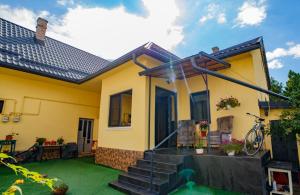 a house with a green lawn in front of it at AcAsA in Turda