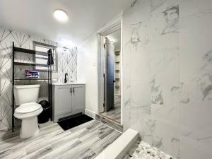a bathroom with a toilet and a walk in shower at 1br Orlando Studio Kitchenette Pets Ok in Orlando +21 photos