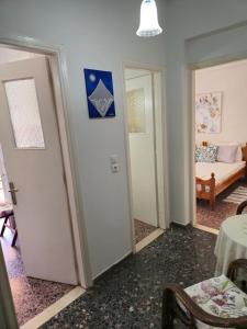 a room with two doors and a room with a bed at loutraki apartment in Loutraki