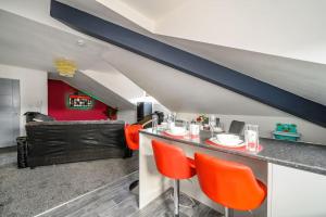 a living room with a bar with orange chairs at -4F421- For your Relaxed,Cosy stay,Free Parking in Batley