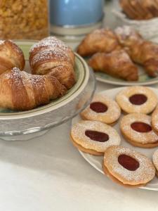 two plates of pastries and croissants on a table at Villa Rosa in Agropoli