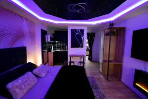 a living room with purple lights on the ceiling at Suite Luxe Balnéo & Sauna coeur du Havre, exterieur prive in Le Havre