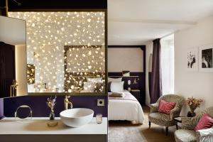 迪南Clos du Cèdre - Chambres d'Hôtes d'Exception, Luxury B&B à Dinan的带水槽和卧室的酒店房间