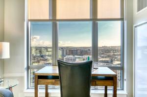 a dining room with a table and a large window at Gorgeous Apt Near Restaurants in Quincy