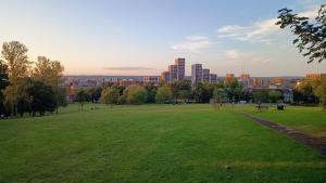 a park with a city in the background at Luxurious London Studios in Harrow