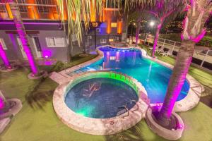 an overhead view of a swimming pool with palm trees at Enjoy 360 in Villa Carlos Paz +13 photos