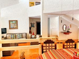 a living room with a couch and a table at Casa Saltwater Cowboy En La Playa - Beachfront Property in Chuburná