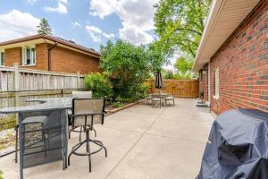 a patio with chairs and a table and a brick building at Full house - 5 bed, 2 bath in Windsor