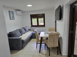 a living room with a couch and a table at Nova Panorama in Vrdnik