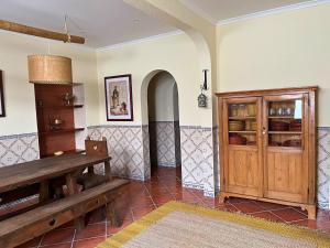 a room with a table and a wooden cabinet at Casa do Viajante in Cabeção