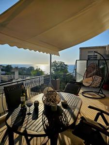 a table and chairs on a balcony with a view of the ocean at Chistina’s brand new apartment in Kyparissia