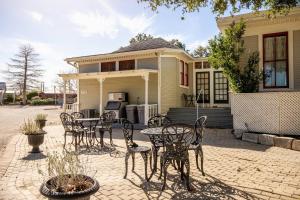a table and chairs in front of a house at #14 The Country Suite at Garrison in Gruene in New Braunfels