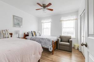 a bedroom with two beds and a ceiling fan at Grand Carytown family home 6BR FREE parking in Richmond