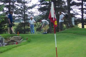 a group of men playing golf on a golf course at Maison au calme dans la verdure in Raucoules