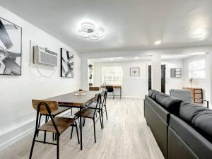 a living room with a table and a couch at Family-friendly 2br Wi-fi Pets Near Disney in Orlando +17 photos