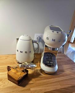 a coffee maker sitting on top of a wooden table at Jurta na Wypasie - luksusowy namiot z widokiem na góry - Jacuzzi, Sauna, Split AC, Private, Star View in Zakopane +18 photos