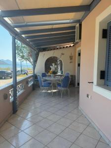 a patio with a table and chairs on it at Dimitris Guesthouse in Kapótidhes