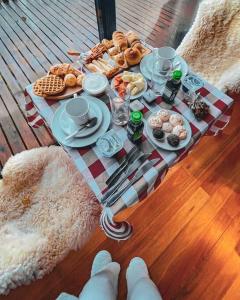 a table with breakfast food on a deck at Cabana The Wild Urubici in Urubici
