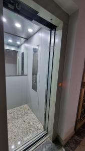 a room with a glass wall with a mirror at Appartement Mima Marrakech Proche centre ville, cosy et spacieux in Marrakech