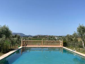 a large swimming pool with a wooden fence around it at Casa Santa María by CasaTuristica in Ronda