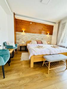 a bedroom with a large bed and a brick wall at B&B Villa Plitvica in Plitvica Selo