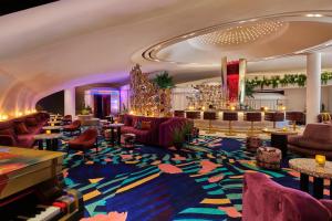 a lobby with couches and a grand piano at Virgin Hotels Las Vegas by Suiteness in Las Vegas +103 photos
