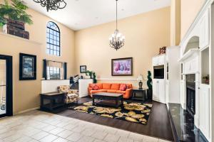 a living room with an orange couch and a fireplace at Best Western StateLine Lodge in West Siloam Springs